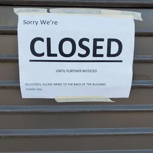 Outside. Gate is down and signage on door says CLOSED TEMPORARILY. 1/6/2023.