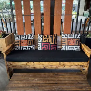 Outdoor seating area with pillows made from West African fabric. Beautiful!