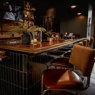a bar with chairs and a television