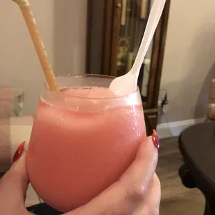 a person holding a glass of a drink