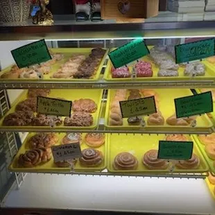 a variety of donuts in a display case
