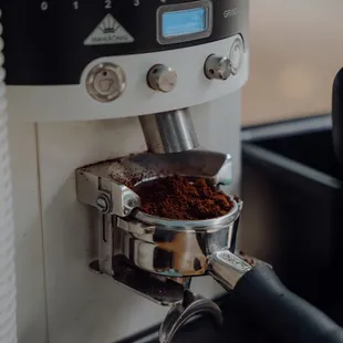 a coffee grinder with ground coffee
