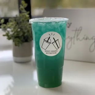 a green drink in a plastic cup
