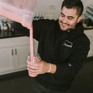 a man pouring a drink