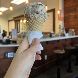 a hand holding an ice cream cone