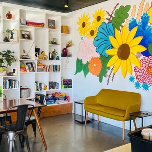 My favorite part of the shop, the back wall/book wall with wall art.