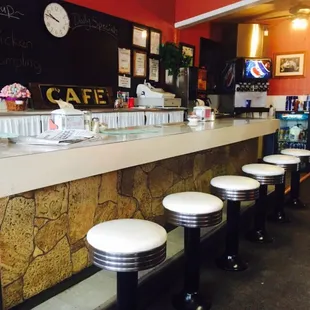 a row of stools at the counter