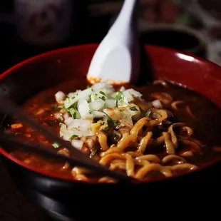 a bowl of ramen and a spoon