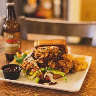 a plate of food and a bottle of beer