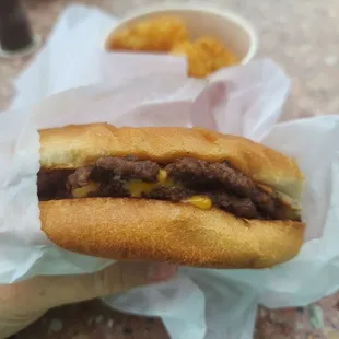 a hand holding a sandwich