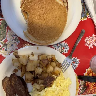 Hot cakes with hash brown, scrambled eggs, and bacon.
