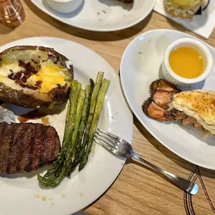 Steak, asparagus, baked potato, and lobster tail