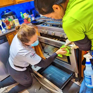 a woman cleaning an oven