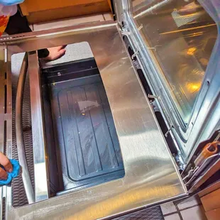 a man in a surgical mask opening an oven door