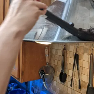 a person cleaning a stove