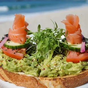 SMOKED SALMON AVOCADO TOAST 
Mash Avocado, Tomato, Cucumber, Chili Flakes, Micro Cilantro Greens and Sesame Seeds on Sourdough Bread