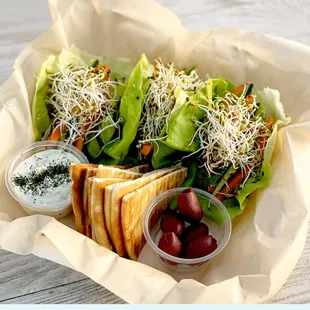 Veggie Jo 
Cucumber, Carrots, Sprouts, Tomato, Red Onion, Avocado, on a Butter Lettuce Wedge, Tzatiki or hummus, Pita Bread, and olives