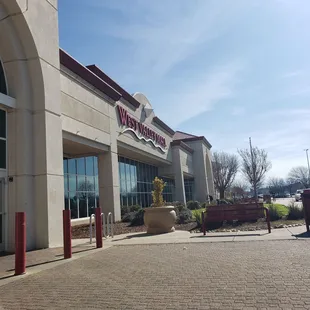 Sitting outside the left side entrance.