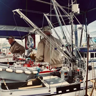 a man standing next to a boat