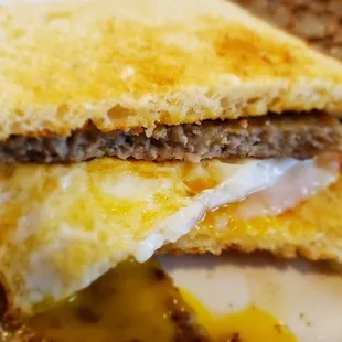 a breakfast sandwich with eggs and sausage