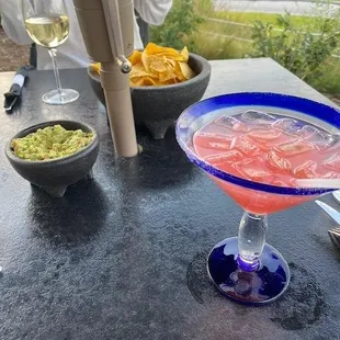 Chips and guacamole, raspberry grapefruit margarita, and chardonnay.