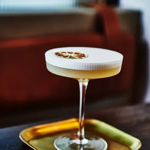 a cocktail in a glass on a tray