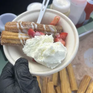 Churros with ice cream fresh strawberries condense milk