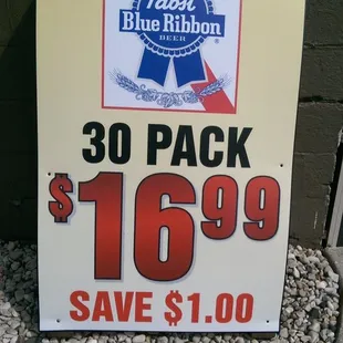 a sign advertising a bottle of blue ribbon