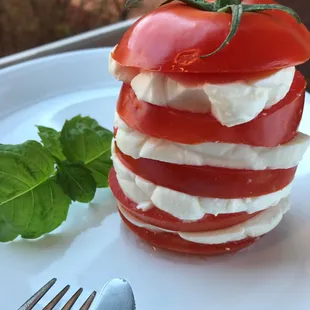 Stacked pomodoro with fresh mozzarella and house pesto..... Irresistible...