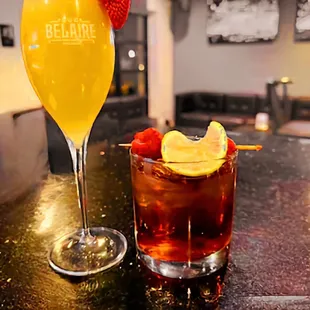 two cocktails on a bar