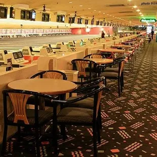 rows of tables and chairs in a bowling alley
