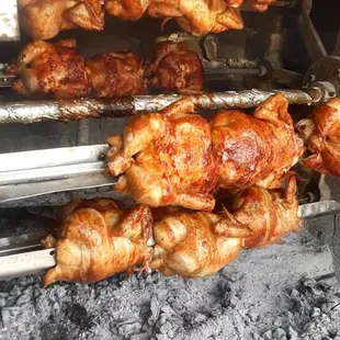 chicken being cooked on a grill