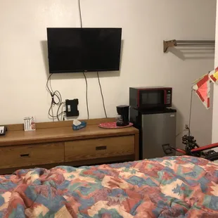 Interior: superbly clean room with the essentials of a mini-fridge/flatscreen TV/microwave