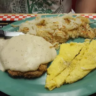 Chicken fried steak with scrambled eggs and hashbrowns