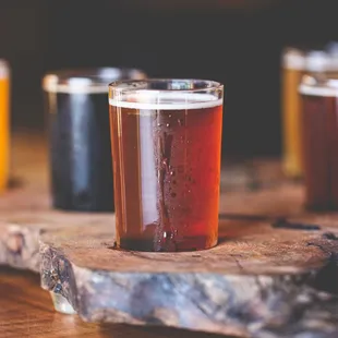 a variety of beers on a wooden board