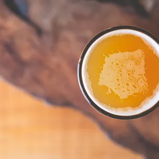 a mug of beer on a wooden table