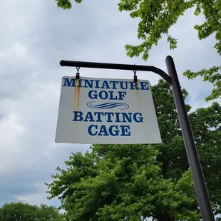 Mini golf and batting cage signage by parking lot
