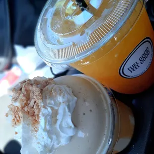 a close up of a drink with whipped cream and coconut flakes