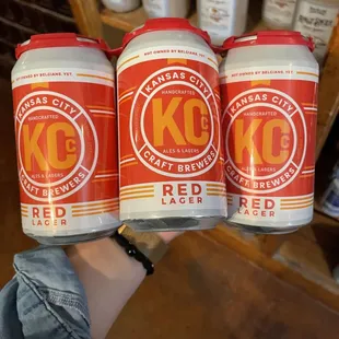 four cans of kc red