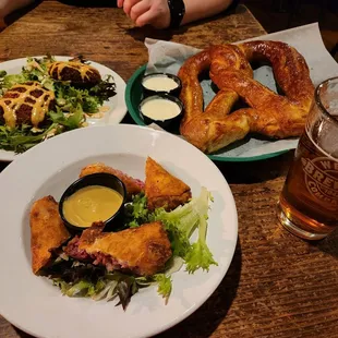 two plates of food and a glass of beer