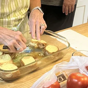 Glenna dipping out some her delicious cream brûlée French toast