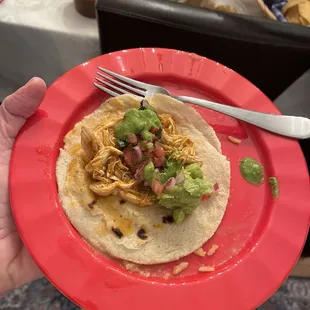 Corn tortilla with chicken, guacamole, beans and rice.