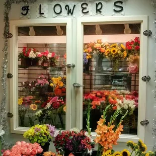 Our display cooler with fresh arrangements and loose cut stems.