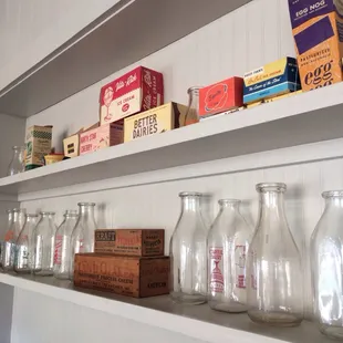 a shelf of milk bottles