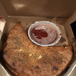 a half eaten pizza in a box