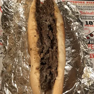 a hot dog wrapped in aluminum foil