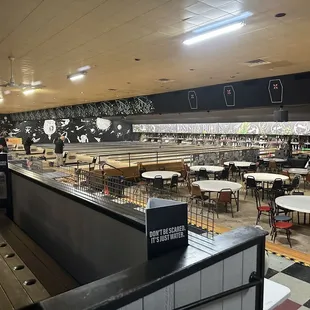 a bowling alley with tables and chairs