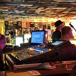 A peek at the audio booth and another look at the expansive fresco of tees.