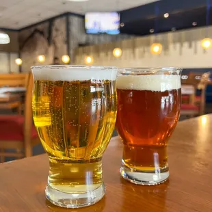 two glasses of beer on a table