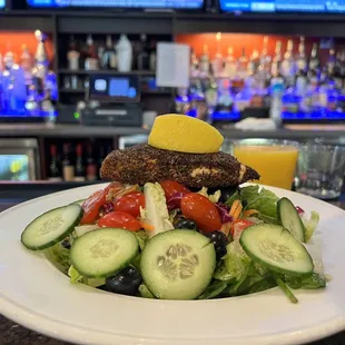 BLACKENED SALMON:  Seared salmon filet, tomatoes, cucumbers, olives, mixed greens, champagne vinaigrette Delicious!